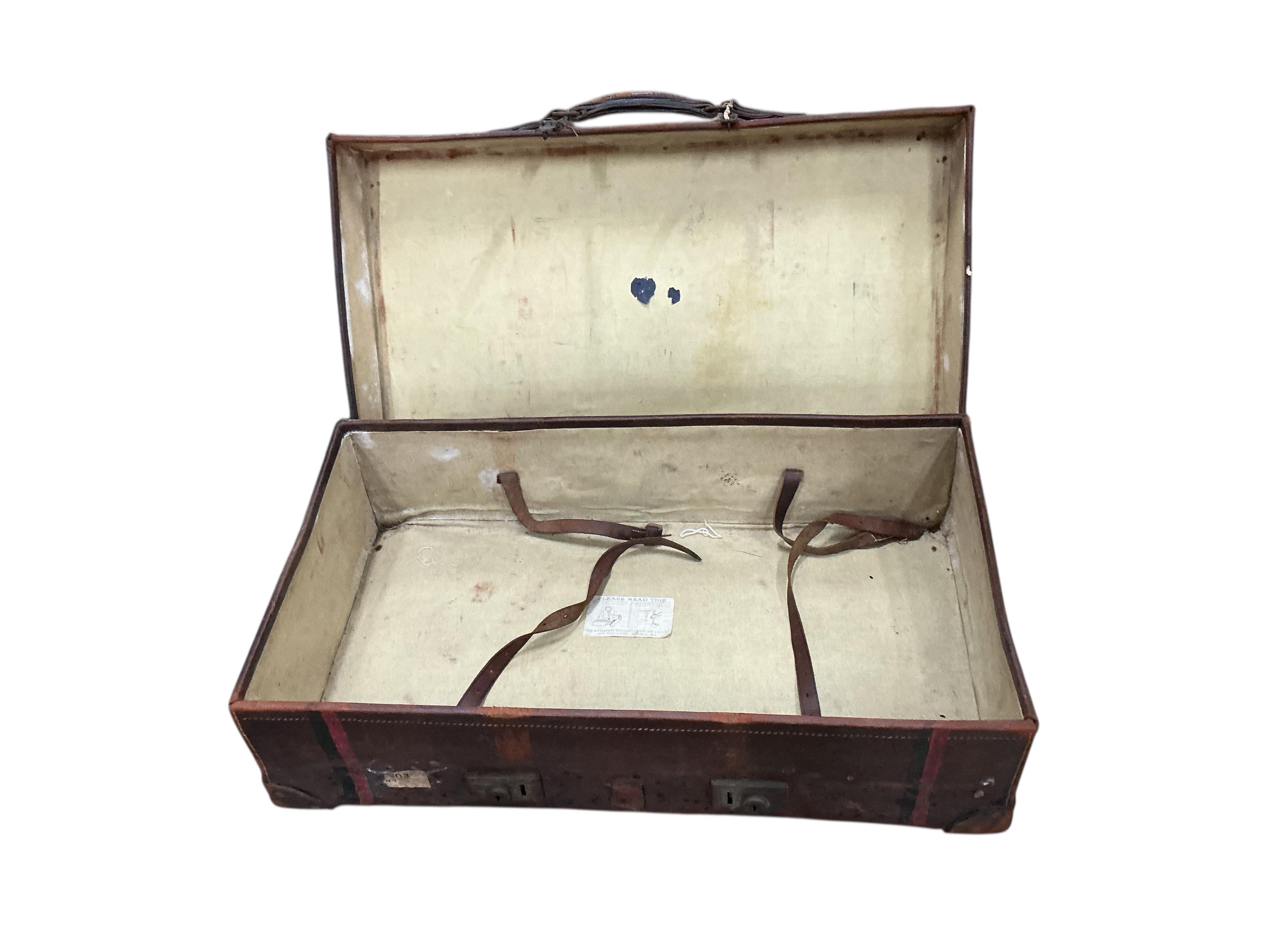 A WWI leather artillery shell case carrier, height 98cm, a wicker laundry hamper and a Revelation leather case